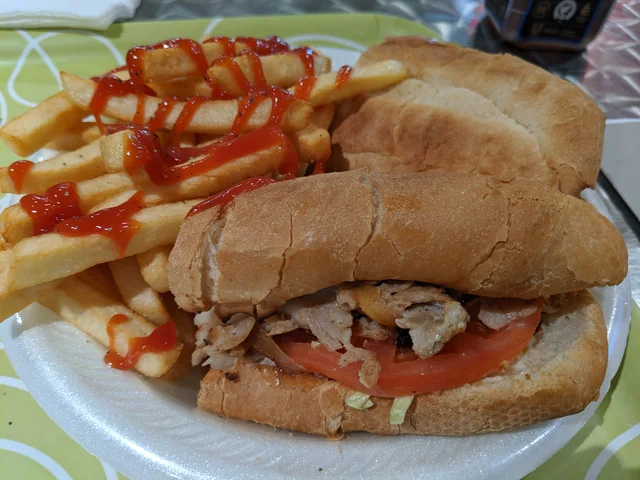 French fries with ketchup beside a sandwich on a plate at Avenue Cafe.
